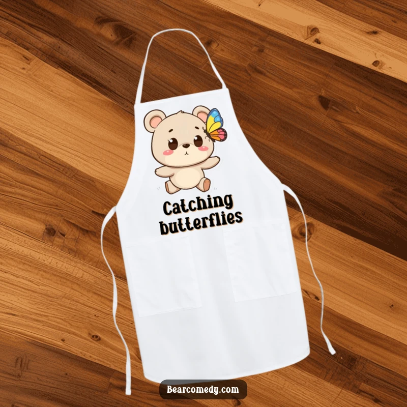 Funny apron featuring a bear character with wide eyes chasing a butterfly, ideal for humorous and nature-themed kitchen activities.