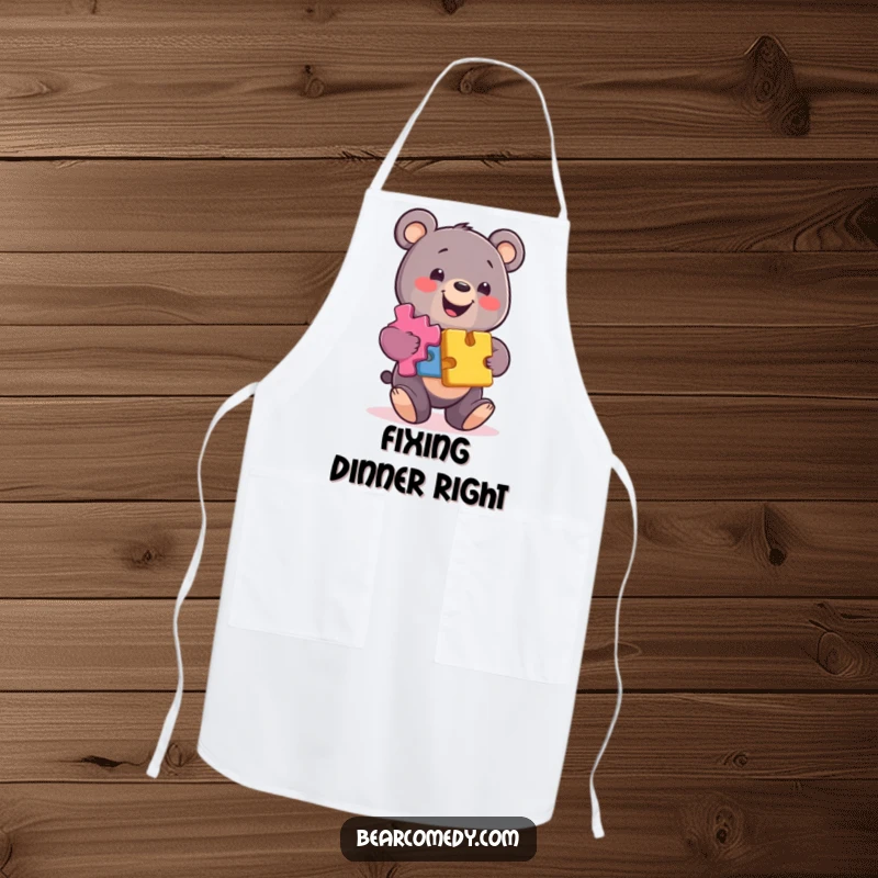 Funny bear apron showing a smiling character balancing colorful puzzle pieces, adding a clever touch to kitchen tasks.