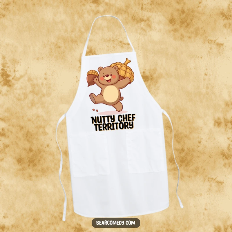 Funny apron print: A bear joyfully kicks a huge, bouncing acorn, a fun and energetic kitchen accessory.