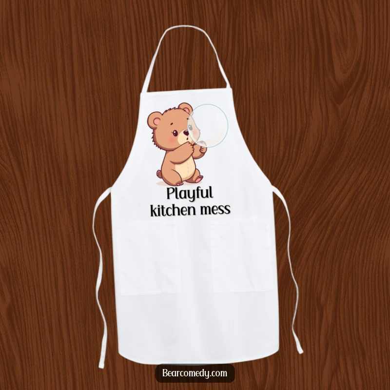 Funny apron featuring a bear cub playfully batting at a large, bouncing bubble, perfect for adding fun to cooking and baking.