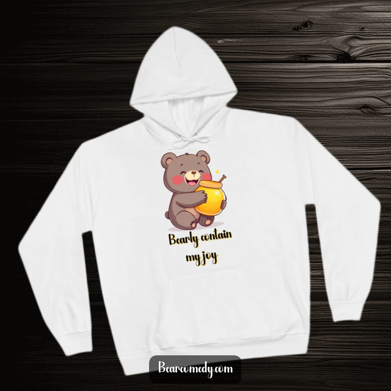 Funny hoodie depicting a bear with a wide smile, giving a big hug to a radiant, oversized honey pot.