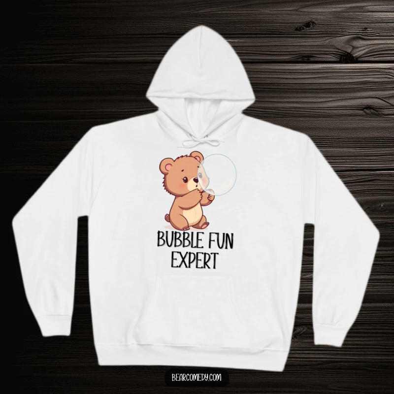 Funny hoodie depicting a bear cub gleefully batting at a large, floating bubble, bringing a sense of wonder and lighthearted playfulness.