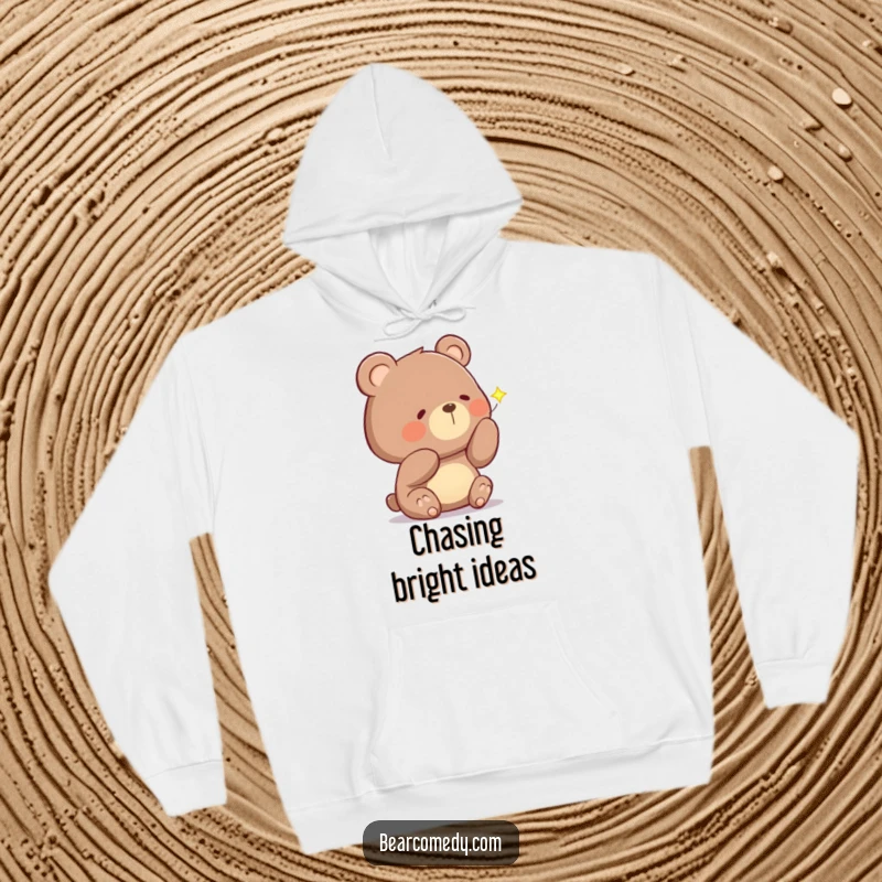 Funny hoodie depicting a bear with a curious head tilt, examining a sparkling firefly, symbolizing nighttime enchantment and comfort.