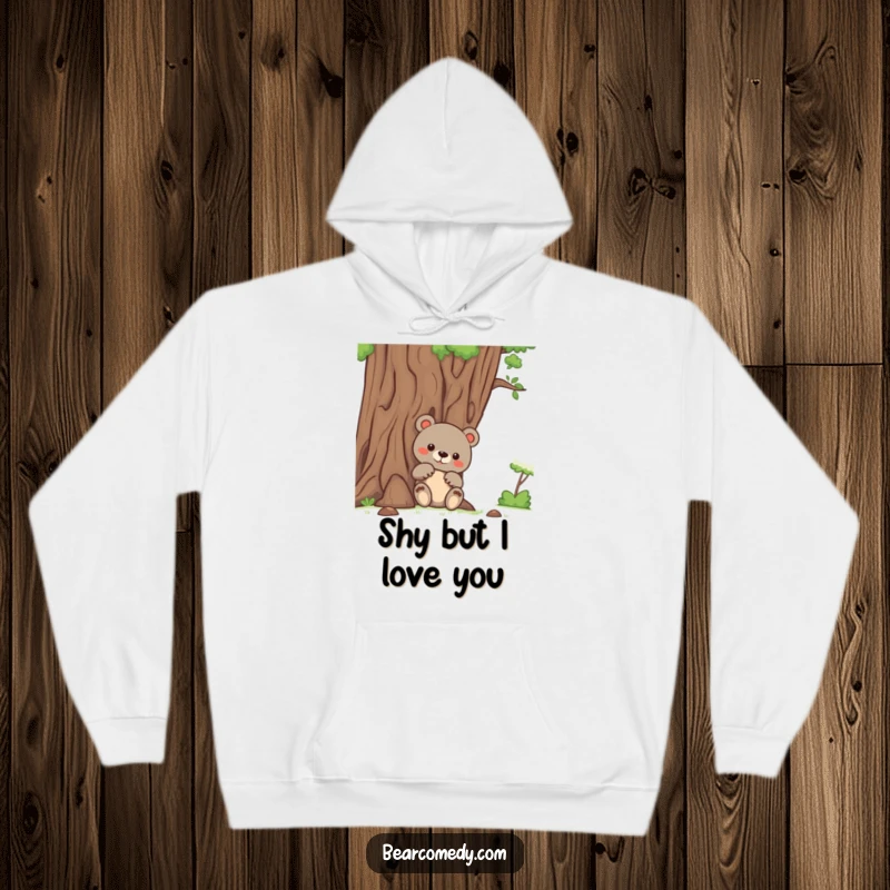Funny bear hoodie featuring a bear peeking curiously from behind a large, friendly tree, blending comfort with playful intrigue.