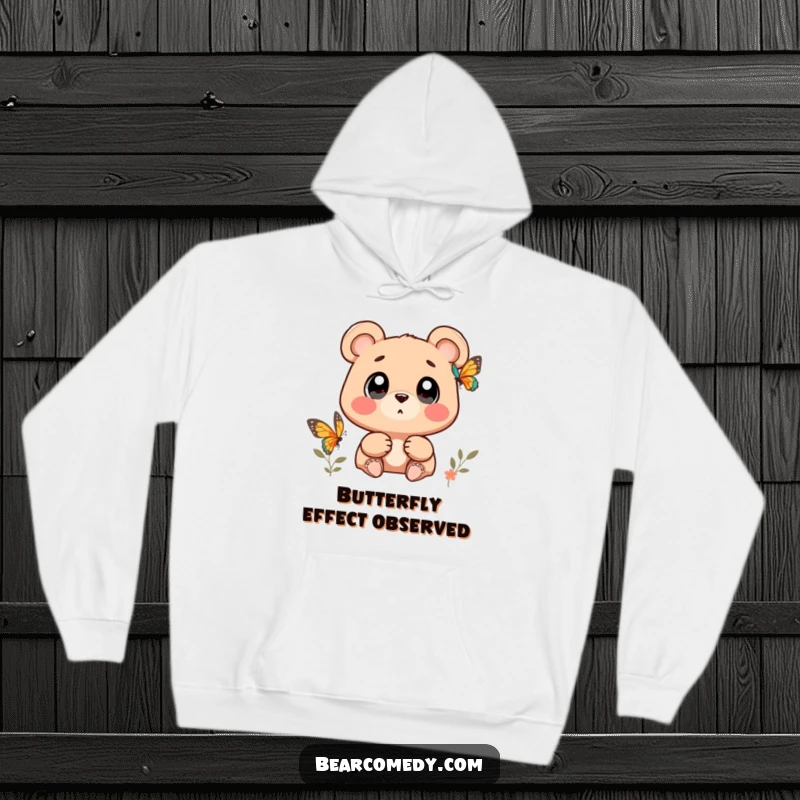 Funny bear character with wide, wondering eyes watching a butterfly on a cozy hoodie, inspiring wonder.