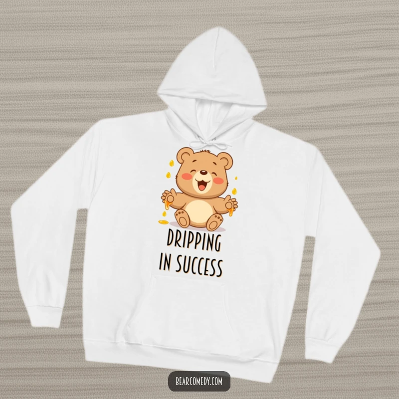 Funny hoodie with a bear's paws outstretched, gleefully catching falling honey droplets, a symbol of sweet, sticky joy.