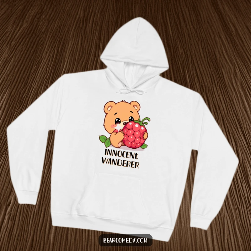 Funny hoodie with a bear character, wide innocent eyes, curiously sniffing a giant, sparkling berry, epitomizing gentle exploration.