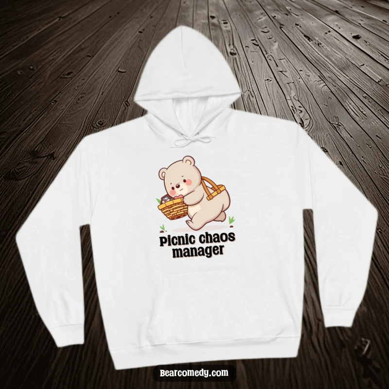 Funny hoodie showing a playful bear character comically tripping while overloaded with an oversized picnic basket.