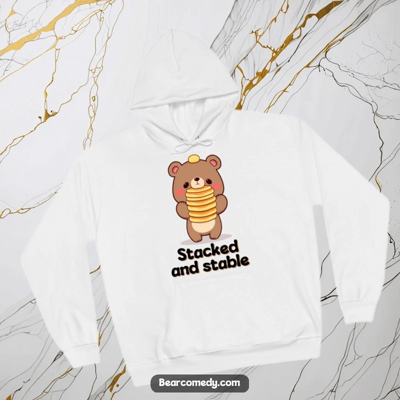Funny bear character balancing a tall stack of pancakes on its nose, a warm and humorous hoodie.