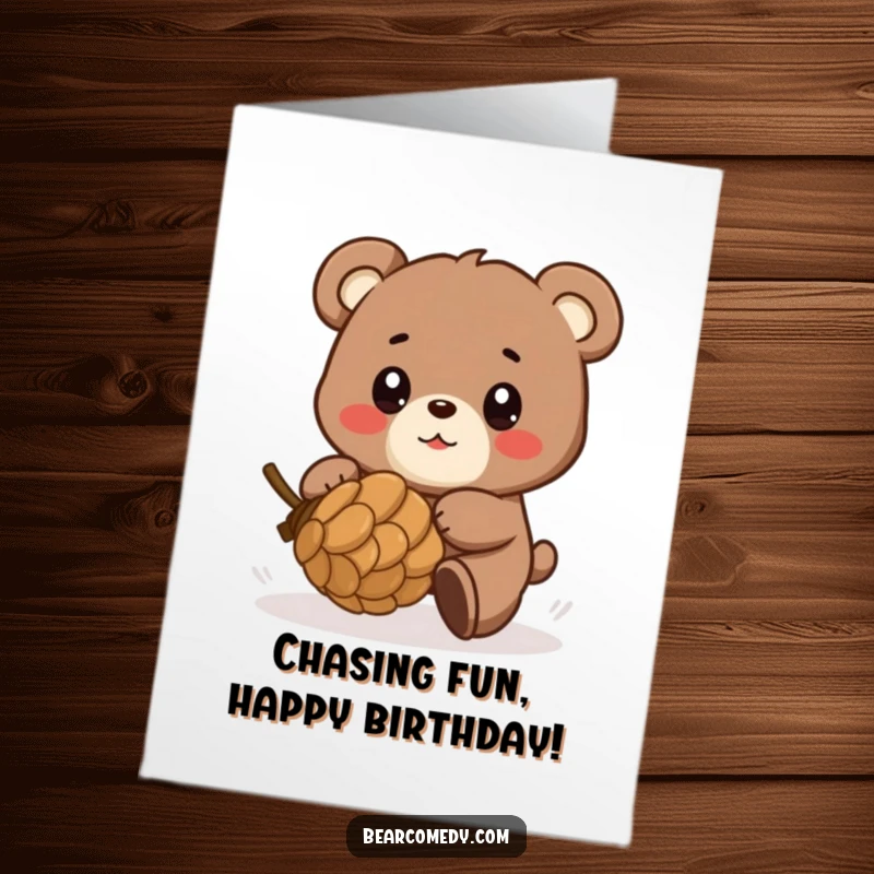 Funny Free Printable Birthday Card: Bear playfully chasing a rolling pinecone, eyes shining with glee.