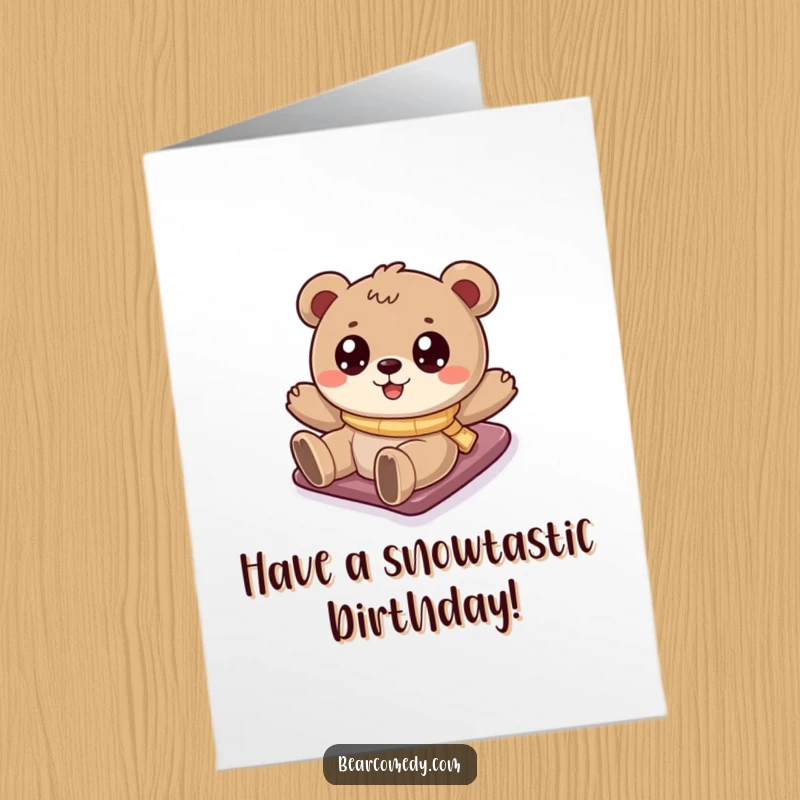 Funny Free Printable Birthday Card: A cartoony bear with sparkling eyes joyfully slides down a snowy hill, celebrating the season.