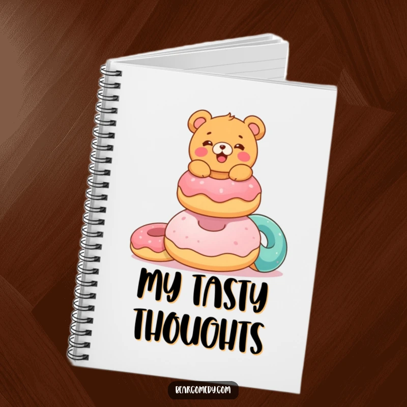 Funny notebook with a delighted bear characterebalancing colorful, giant donuts on the cover, ideal for notes and doodles.