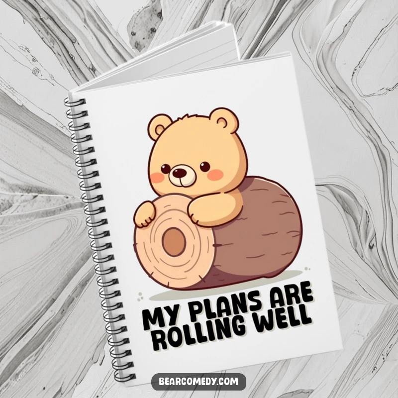 Funny notebook cover showing a bear character giving a determined nudge to roll a giant, round log.