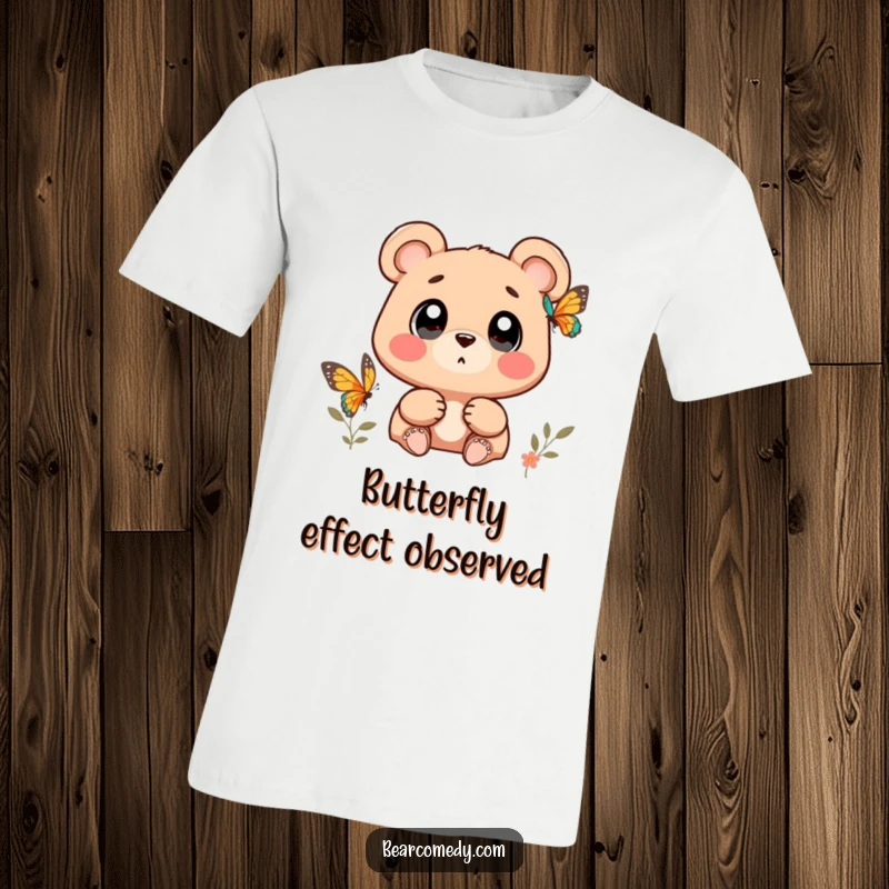 Funny bear character with wide, wondering eyes watching a butterfly on a t-shirt, showcasing curiosity.