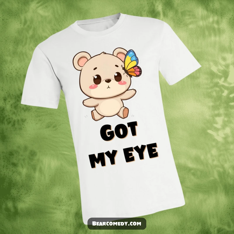 Funny t-shirt showing a bear character with wide eyes chasing a vibrant butterfly, symbolizing playful exploration and outdoor joy.