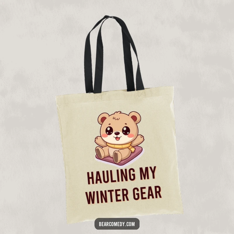 Funny bear tote bag showing a cartoony bear with sparkling eyes sliding down a snowy hill, perfect for carrying winter essentials.