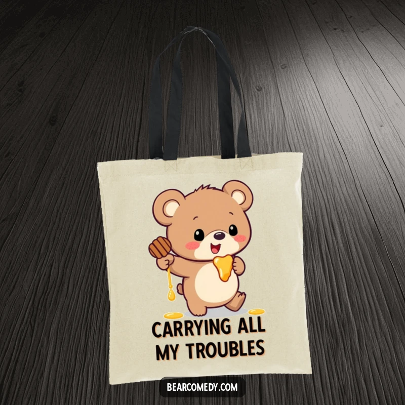 Funny tote bag showing a bear with giant ears comically tumbling while clutching a pot of dripping honey.